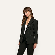A woman wears a black Kyomi Double-Breasted Blazer in stretch suit fabric with satin lapel detailing over a white top.