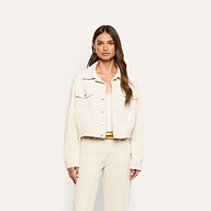 A woman wearing a pearl white Alessia Corduroy Jacket over a matching top and pants.