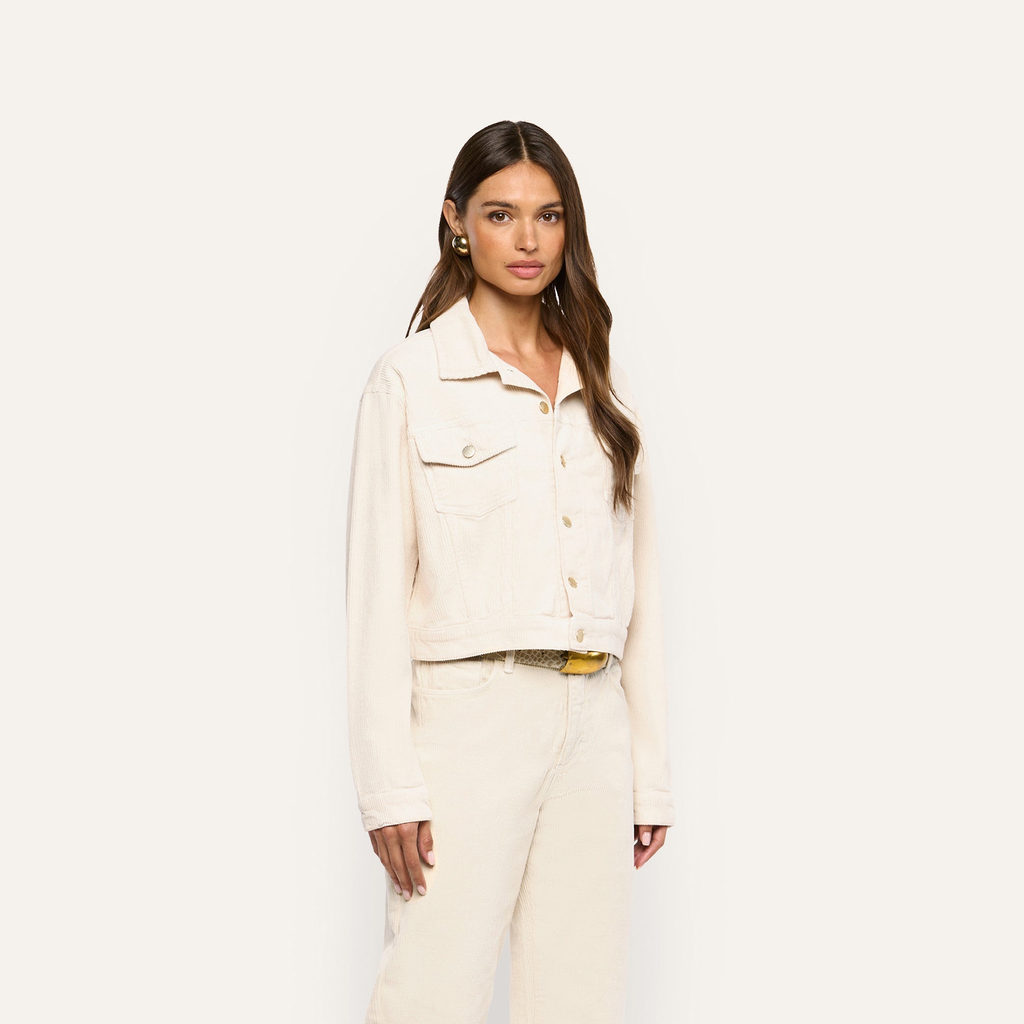 Woman wearing an Alessia Corduroy Jacket in pearl white and matching trousers.