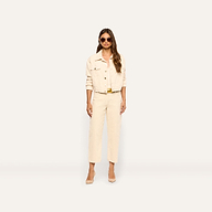 A woman wearing an Alessia Corduroy Jacket in pearl white with matching trousers and tan heels.