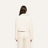 Back view of a person wearing a pearl white, cropped Alessia Corduroy Jacket and matching trousers.