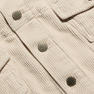 Close-up of a cropped pearl white Alessia Corduroy Jacket with a stretch corduroy texture and metal buttons.