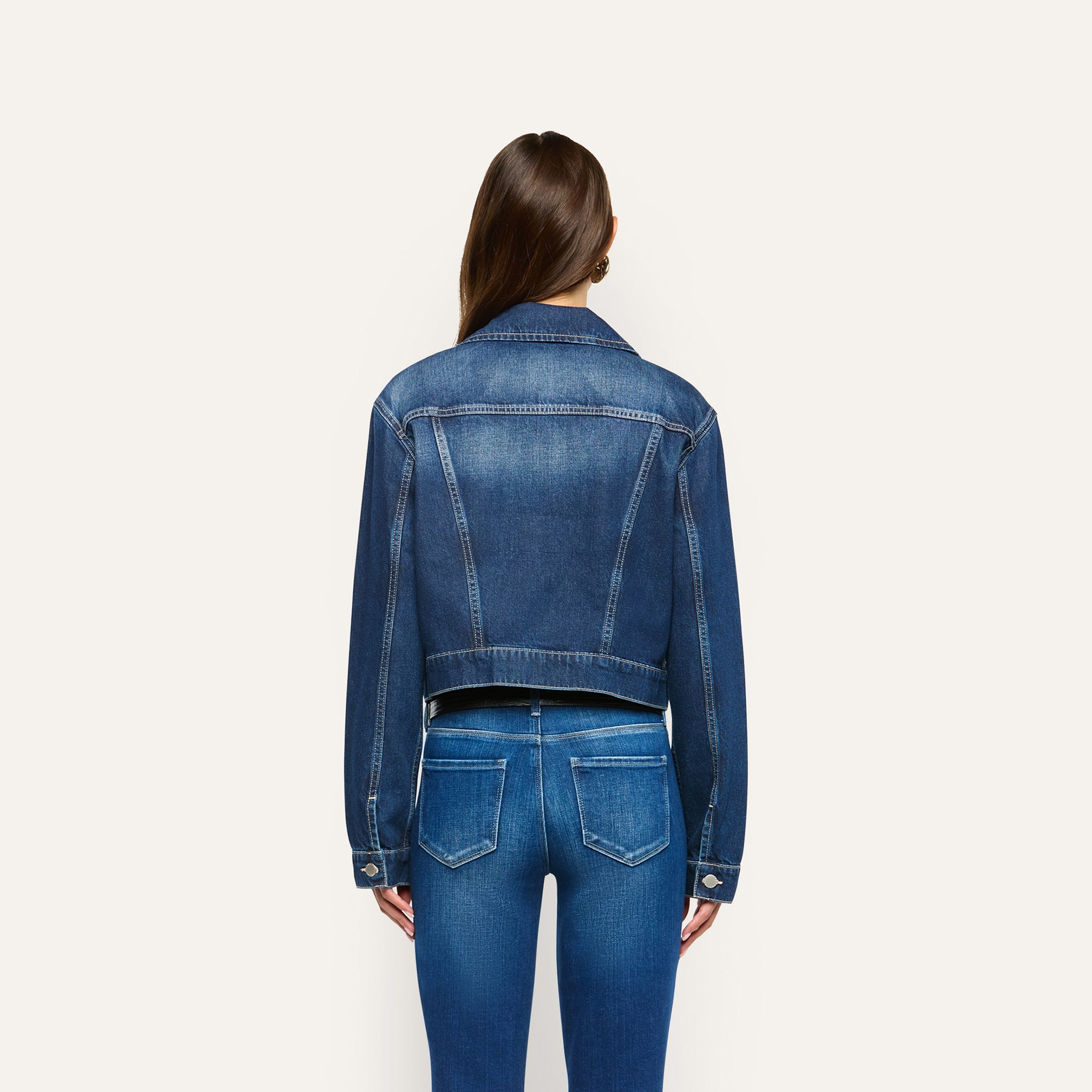 A person viewed from behind, wearing an Alessia Jean Jacket and matching jeans.