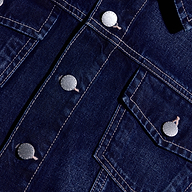 Close-up of the Alessia Jean Jacket in dark denim, featuring silver-tone metal buttons and contrast stitching.
