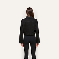 Back view of a person wearing a black cropped Alessia Jean Jacket.
