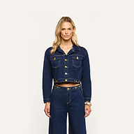A person wearing an Edin Jean Jacket in cropped indigo wash denim with gold-tone buttons and matching wide-leg jeans.