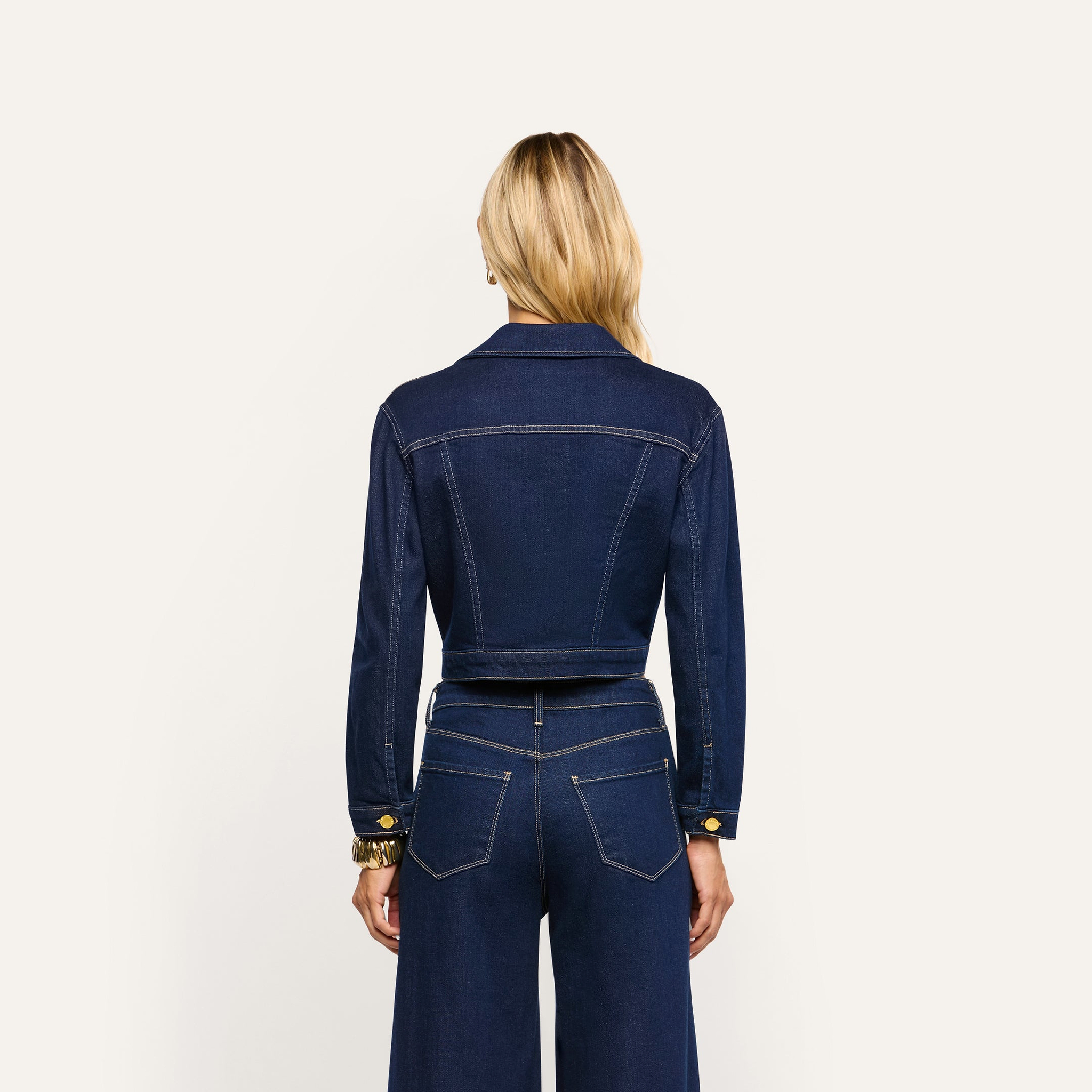 Back view of the Edin Jean Jacket in a cropped indigo wash, worn with matching wide-leg jeans.