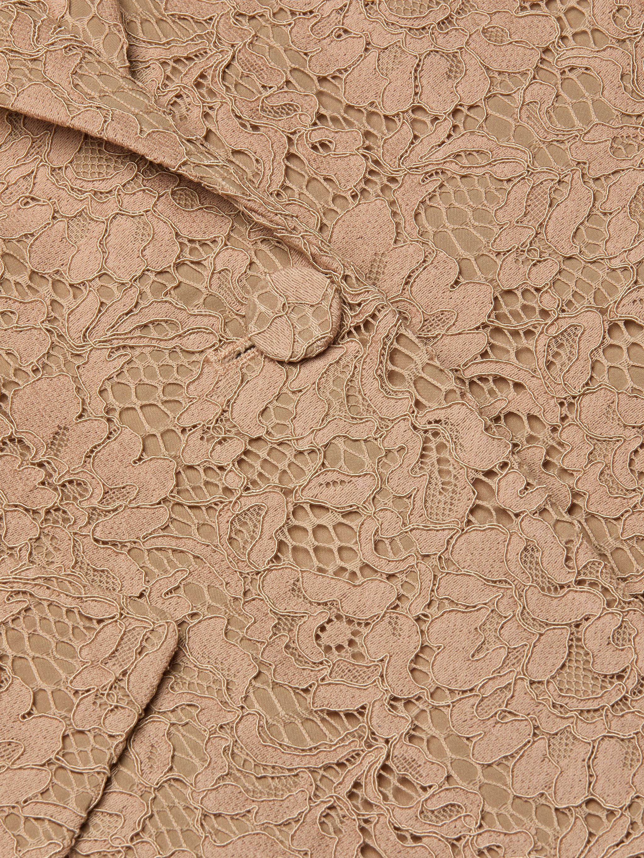 Close-up of the Chamberlain Lace Blazer in beige, showcasing intricate floral lace patterns and visible stitching that highlight the fabric’s texture and delicate details—perfect for achieving an office-ready style.