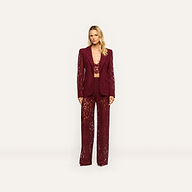 A model wears a matching deep port red Chamberlain Lace Blazer, crop top, and wide-leg trousers in a classic design.