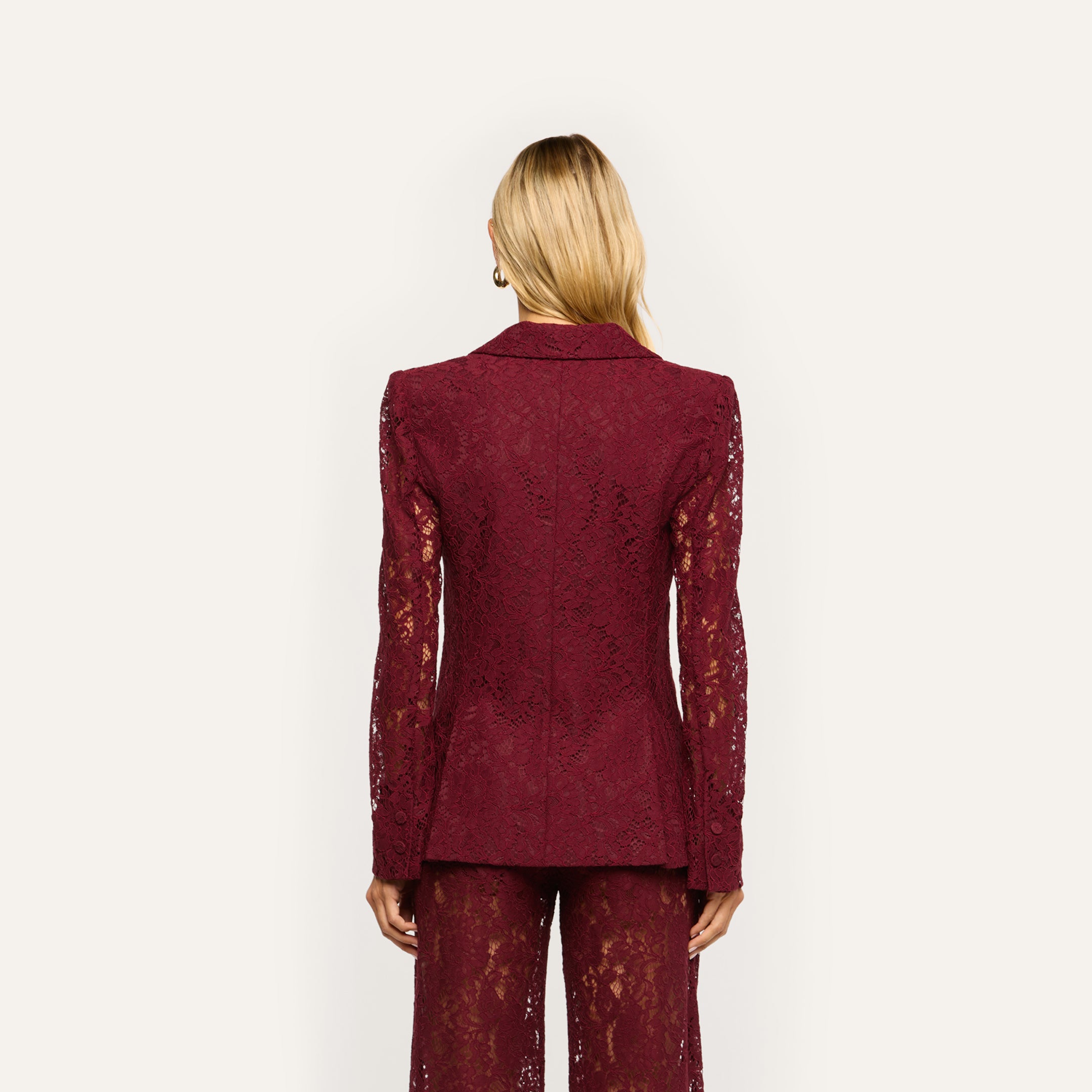 Back view of a person wearing a structured maroon Chamberlain Lace Blazer in a classic design.