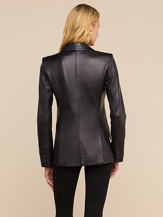 A woman with long blonde hair is shown from the back wearing the fitted Chamberlain Leather Blazer, which features peaked lapels, along with black pants against a plain light background.