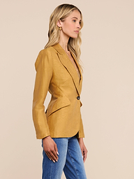 A woman with long blonde hair, wearing the Chamberlain Linen-Blend Blazer and blue jeans, stands in profile against a plain white background.