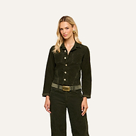 A woman with long blonde hair wears the Janelle Corduroy Jacket and matching green pants with a belt, standing against a plain light background.