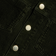 Close-up of the Janelle Corduroy Jacket in green, featuring three round metallic buttons and prominently stitched pocket seams.
