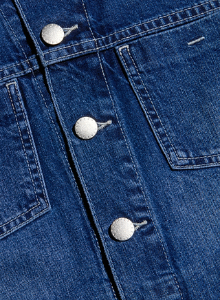 Close-up of the Janelle Jean Jacket in a medium wash and slim fit, featuring four metallic snaps down the center and two pockets on either side of the seam.
