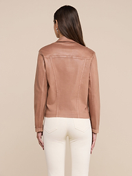 A woman with straight brown hair is shown from the back against a plain, light background, wearing the Janelle Coated Jean Jacket in a slim fit hazelnut brown color paired with white pants.
