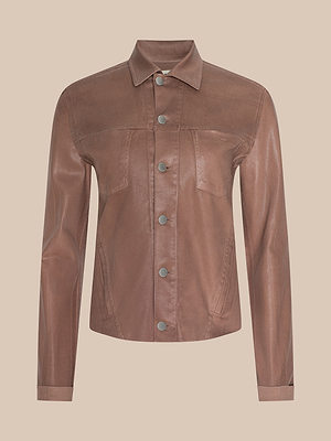 The Janelle Coated Jean Jacket, shown in hazelnut brown with a slim fit, long sleeves, a button-down front, two chest pockets, and a collar is displayed against a neutral beige background.