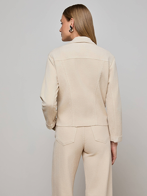 A woman with straight, light brown hair stands with her back to the camera, wearing the L'AGENCE Janelle Corduroy Jacket in a slim fit with three-quarter sleeves and matching pants, accessorized with black earrings against a plain background.