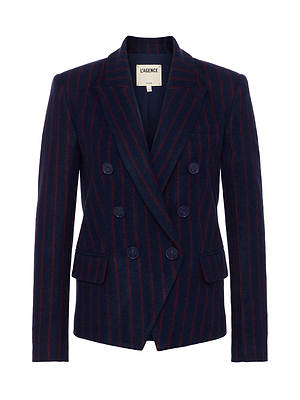 The Kenzie Pinstriped Blazer by L'AGENCE is a navy wool blend double-breasted blazer with red vertical pinstripes, peaked lapels, and flap pockets, shown on a plain white background.