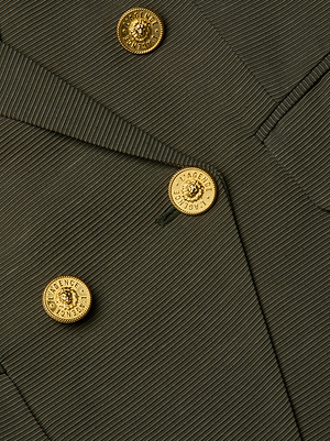 Close-up of the L'AGENCE Kenzie Double-Breasted Blazer, showcasing its dark textured fabric, gold embossed buttons with decorative designs, and prominently displayed lapel and button arrangement.