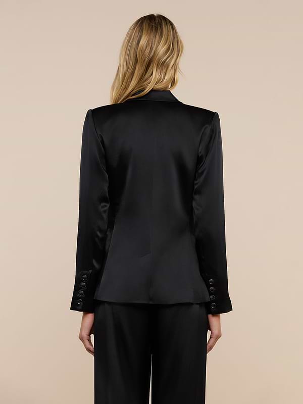 A woman with blonde hair is shown from the back wearing the Colin Silk Charmeuse Blazer and matching pants against a plain light background.