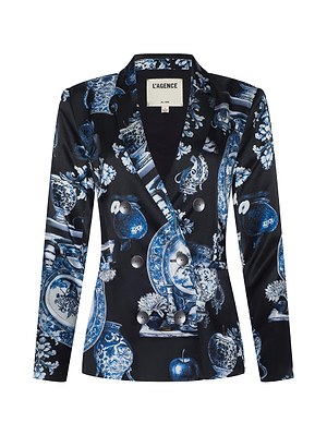 The Colin Silk Blazer by L'AGENCE features a blue and white porcelain-inspired print, long sleeves, silver buttons, a notched lapel, and is crafted from luxurious silk charmeuse.