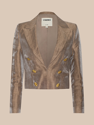 The Inez Cropped Blazer—a metallic brown jacket with gold buttons and a deep V-neck—is shown against a beige background, featuring the “L’AGENCE” label inside. This chic cropped blazer provides a modern update to classic tailoring, making it ideal for elevating any outfit.