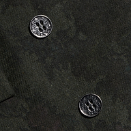 Close-up of the Jayda Blazer’s dark Italian wool blend fabric with two four-hole metallic buttons. The rich texture of the fabric and the glossy finish of the buttons are clearly highlighted.