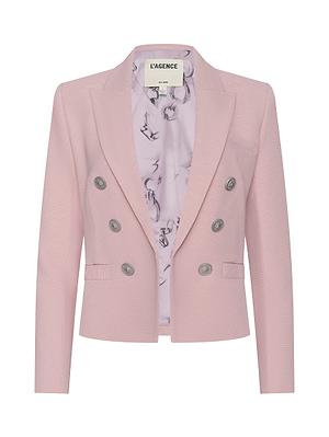 The Brooke Open-Front Blazer is a pale pink, double-breasted design with silver buttons, two front pockets, patterned light lining, and lightweight ribbed fabric. Displayed on a plain white background, the label reads LAGENCE.