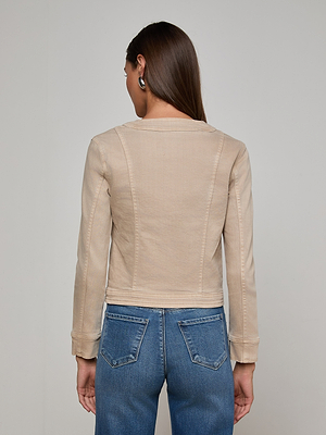 A woman with long brown hair wears the L'AGENCE Yari Jean Jacket and blue stretch denim jeans, standing with her back to the camera against a light gray background.