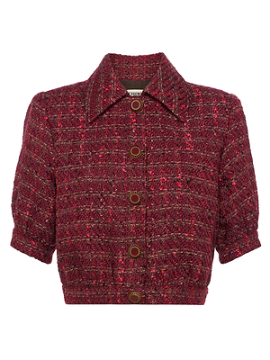 The Cove Cropped Tweed Jacket by L'AGENCE features puff sleeves, a collar, and vintage-inspired gold buttons. Made from textured red and pink fabric, it offers a chic, statement look.