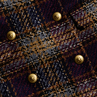 Close-up of the Kolina Tweed Long Coat’s textured plaid fabric in dark blue, brown, and gold tones, featuring six shiny round gold buttons arranged in two columns.