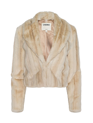 The Davy Faux Fur Jacket by L'AGENCE is a light beige cropped jacket with plush faux fur, a wide collar, and long sleeves. Its soft, cozy texture contrasts with the white background. The inner label displays the L'AGENCE brand.