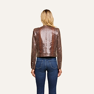 A woman with long blonde hair, seen from behind, wears the Jayde Coated Suede Jacket and blue jeans, standing against a plain white background.