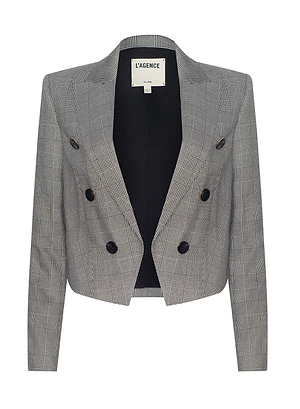 The Lila Tweed Blazer is a cropped, double-breasted gray plaid jacket with six black buttons, long sleeves, notched collar, and black lining featuring a sewn L’AGENCE label. From the Fall 2026 historical romance collection.