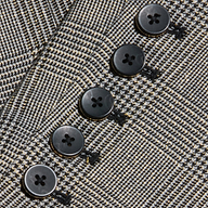 Close-up of five black buttons sewn in a row on the textured houndstooth fabric of the Lila Tweed Blazer, with visible stitching enhancing its modern classic style.