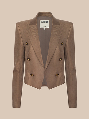 The Lila Linen-Blend Blazer is a brown, double-breasted women’s blazer with four buttons and a notched lapel in a modern classic style. Shown on a plain beige background, the inside collar label reads LAGENCE.