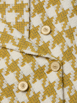 Close-up of the Marie Houndstooth Tweed Blazer shows yellow and white houndstooth tweed, double-breasted styling, and four gold crest buttons.