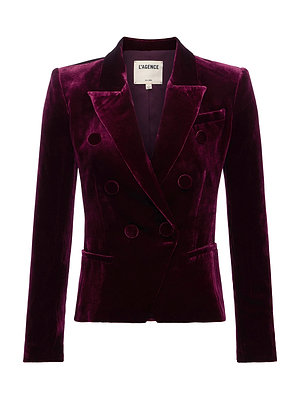 The Marie Velvet Blazer by L'AGENCE is crafted in deep burgundy, silk-blend velvet with wide lapels, black buttons, and two front pockets. This double-breasted blazer is shown against a crisp white background.