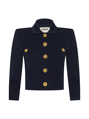 The Kumi Cropped Jacket by L’AGENCE features midnight navy stretch suit fabric, three-quarter sleeves, a collar, two front pockets, and six large gold buttons down the center.