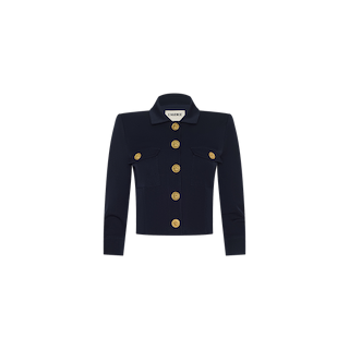 The Kumi Cropped Jacket is a black long-sleeve jacket featuring a collar, two front pockets, and five large gold buttons down the front. Reminiscent of a sleek stretch suit jacket, it is displayed on a plain white background.