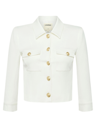 The Kumi Cropped Jacket is a white, cropped style featuring three-quarter sleeves, gold embossed dome buttons down the front, and two breast pockets. The LAGENCE label is visible inside the collar.