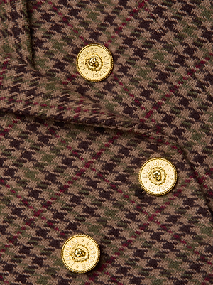 Close-up of the Bethany Houndstooth Blazer by L'AGENCE, showcasing brown and green plaid tweed with four shiny gold lion head buttons embossed with 