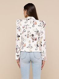A woman with long brown hair is shown from the back against a plain background, wearing the Bethany Structured Blazer with a butterfly print and light blue jeans.