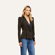 A person wearing the Imogen Satin Lapel Blazer—black with gold vertical stripes—paired with blue jeans stands against a plain, light background.