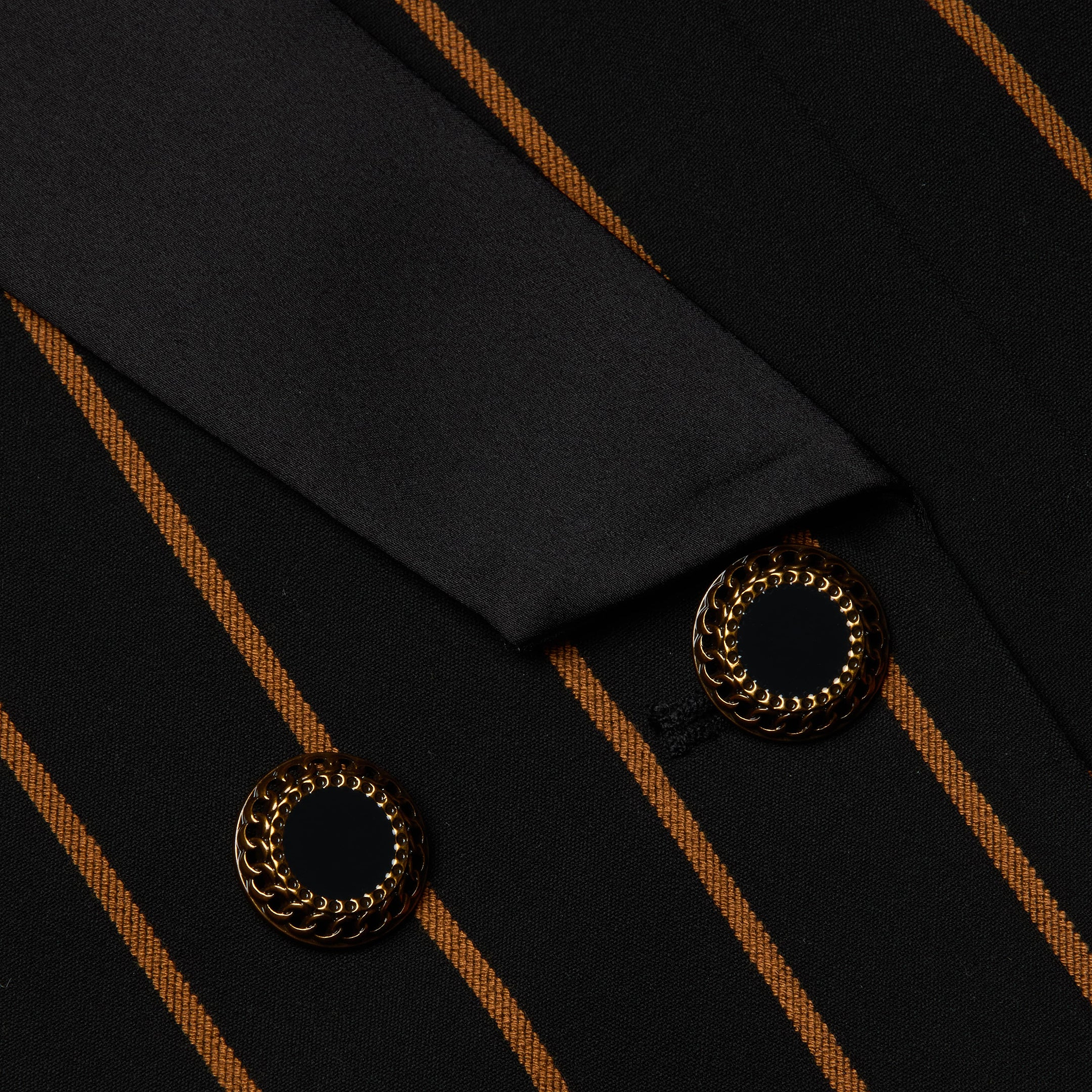 Close-up of the Imogen Satin Lapel Blazer in black fabric with orange-brown vertical stripes, highlighted by two black and gold decorative buttons and a coordinating satin lapel.