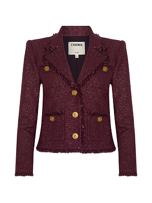 The Sylvia Tweed Jacket by L'AGENCE is a burgundy Italian tweed design featuring gold buttons, frayed edges, front pockets, and a notched collar.