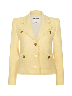 The Sylvia Tweed Jacket is a light yellow tweed piece with gold buttons, frayed edges at the collar, pockets, and hem, notched lapel, and features an inner label that reads LAGENCE.