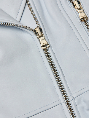 Close-up of the Lyric Peplum Biker Jacket in light blue leather, featuring two silver zippers with metallic pulls and highlighting the detailed texture and stitching on the material.