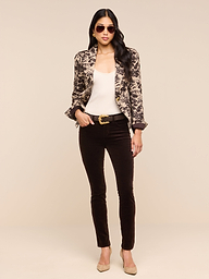 A woman stands confidently against a plain white background, wearing sunglasses, a fitted Kaisley Blazer with an antique-inspired print, a white top, dark pants, and beige heels.